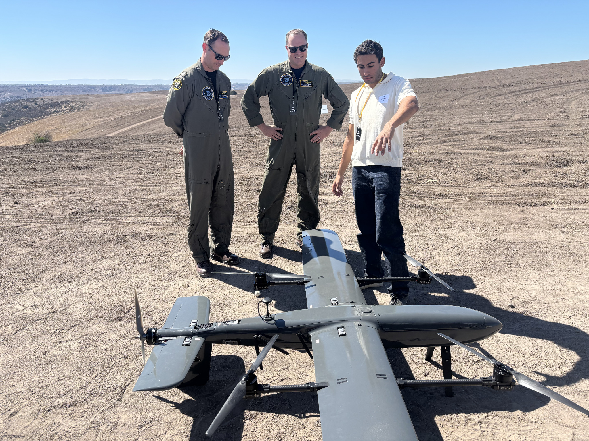 Tanit aircraft being presented to two attendees at the field demonstration